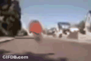 A Blurry Picture Of A Person Riding A Bike On A Street . GIF