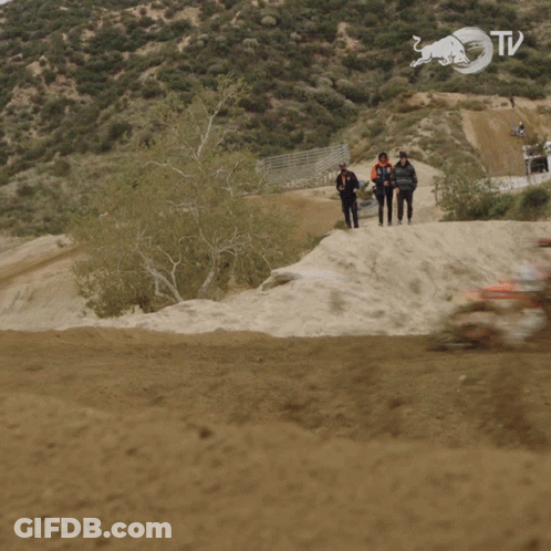 A Blurry Picture Of A Person Riding A Dirt Bike With A Red Bull Logo On The Bottom GIF