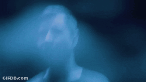 A Blurry Picture Of A Person 'S Face In A Blue Light GIF