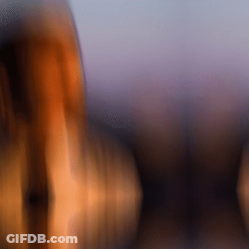 A Blurry Picture Of A Person 'S Face With A Purple Sky In The Background GIF