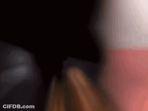A Blurry Picture Of A Person 'S Face With A Red And White Background GIF