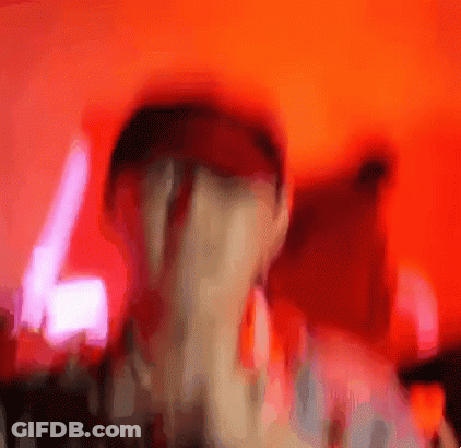 A Blurry Picture Of A Person 'S Face With A Red Background GIF