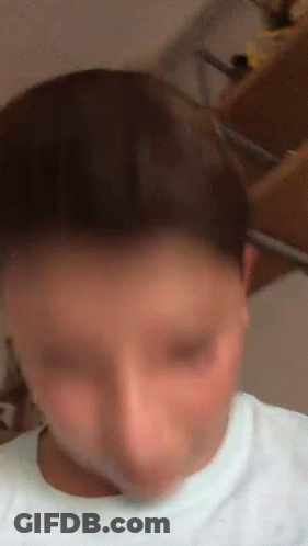 A Blurry Picture Of A Person 'S Face With A White Shirt On GIF