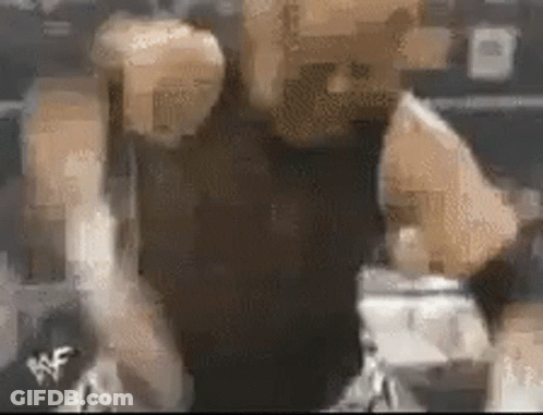 A Blurry Picture Of A Person 'S Face With A Wrestling Logo On The Bottom Right Corner . GIF
