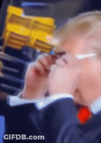 A Blurry Picture Of A Person 'S Face With A Yellow Item In The Background GIF