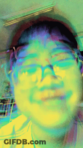 A Blurry Picture Of A Person 'S Face With Glasses On GIF