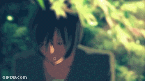 A Blurry Picture Of A Person 'S Face With Leaves In The Background GIF