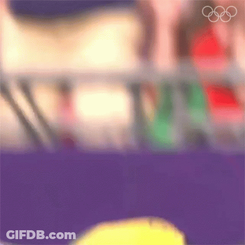 A Blurry Picture Of A Person 'S Face With The Olympic Rings In The Background GIF