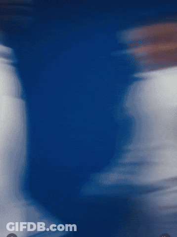 A Blurry Picture Of A Person 'S Torso In A Blue Background GIF