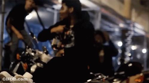 A Blurry Picture Of A Person Sitting On A Bike GIF