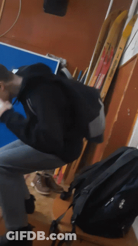 A Blurry Picture Of A Person Sitting On A Chair In Front Of A Blue Table GIF