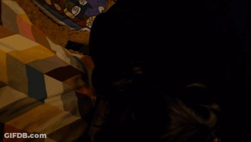 A Blurry Picture Of A Person Sitting On A Couch With Their Legs Crossed GIF