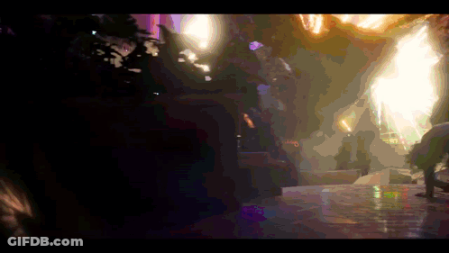 A Blurry Picture Of A Person Standing In A Dark Room With A Purple Light Behind Them GIF