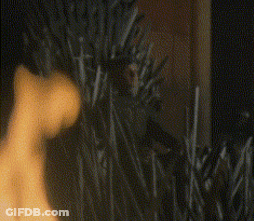 A Blurry Picture Of A Person Standing In A Field Of Tall Grass . GIF