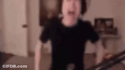 A Blurry Picture Of A Person Standing In A Living Room . GIF