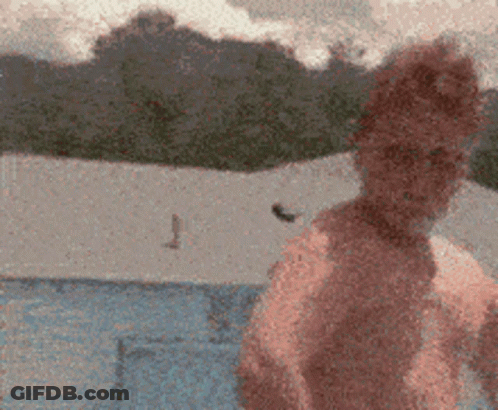 A Blurry Picture Of A Person Standing In Front Of A Blue Tent GIF