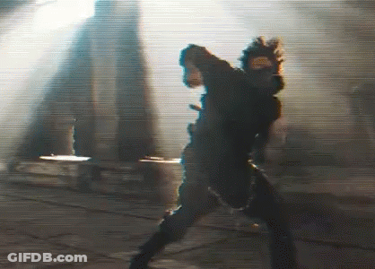 A Blurry Picture Of A Person Standing In Front Of A Building . GIF