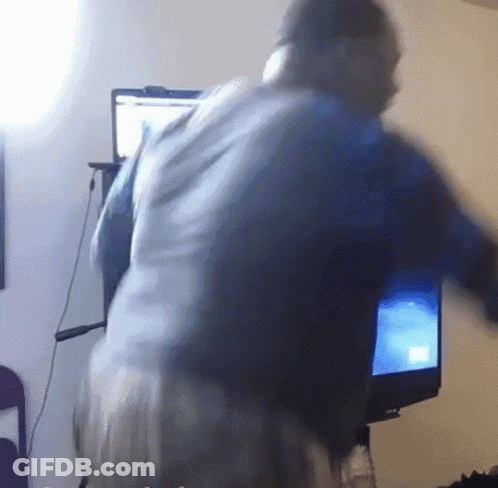 A Blurry Picture Of A Person Standing In Front Of A Computer Monitor GIF