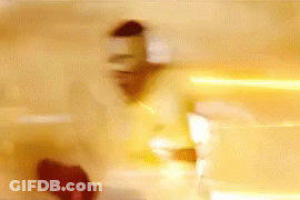 A Blurry Picture Of A Person Standing In Front Of A Wall With A Light Coming Out Of It . GIF