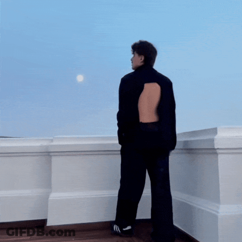 A Blurry Picture Of A Person Standing In Front Of A Window GIF