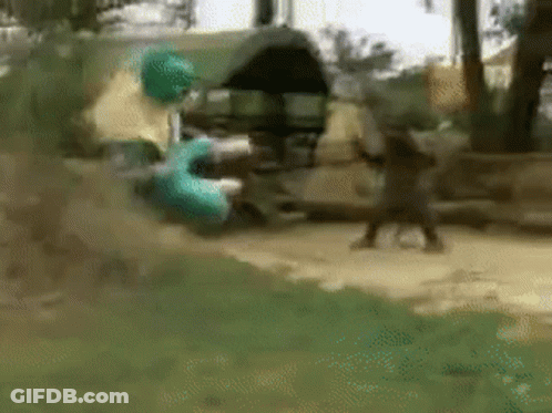 A Blurry Picture Of A Person Standing In The Grass With A Green Object In The Background GIF
