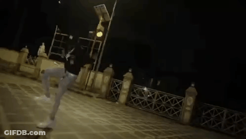 A Blurry Picture Of A Person Standing Next To A Table . GIF