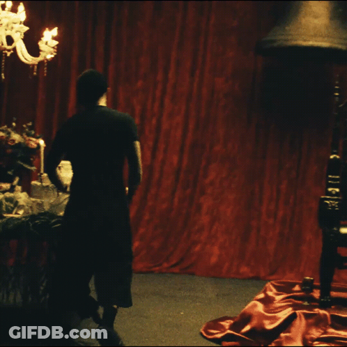 A Blurry Picture Of A Person Standing On A Red Carpet GIF