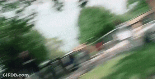 A Blurry Picture Of A Person Walking Down A Sidewalk . GIF