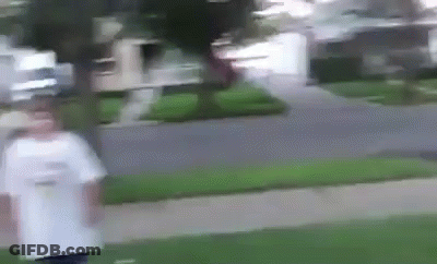 A Blurry Picture Of A Person Walking Down A Sidewalk In Front Of A House . GIF