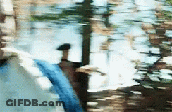 A Blurry Picture Of A Person Walking In A Puddle Of Water . GIF