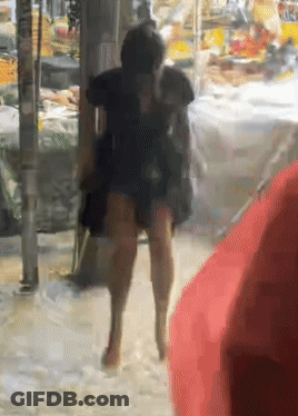 A Blurry Picture Of A Person Walking In The Rain GIF