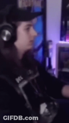 A Blurry Picture Of A Person Wearing Headphones And A Hat GIF