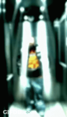 A Blurry Picture Of A Person With A Yellow Shirt GIF