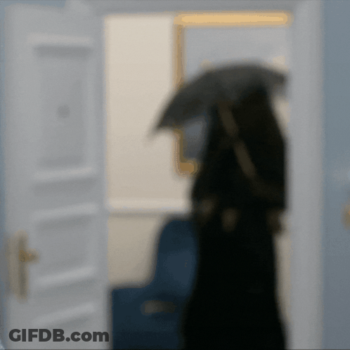 A Blurry Picture Of A Person With An Umbrella GIF