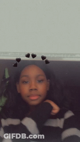 A Blurry Picture Of A Person With Black Hearts On The Wall GIF