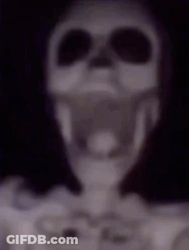 A Blurry Picture Of A Skeleton Wearing Headphones And Sunglasses . GIF