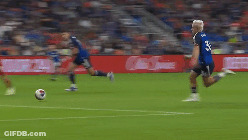 A Blurry Picture Of A Soccer Field With A Sign That Says ' Allianz ' GIF
