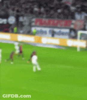 A Blurry Picture Of A Soccer Field With A Sign That Says ' Allianz ' GIF
