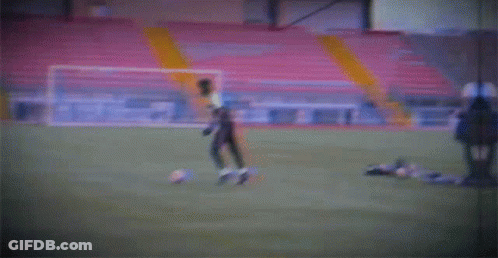 A Blurry Picture Of A Soccer Field With A Yellow Pole GIF