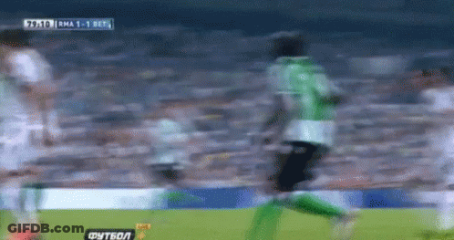 A Blurry Picture Of A Soccer Game With A Score Of 1-0 In The Background GIF