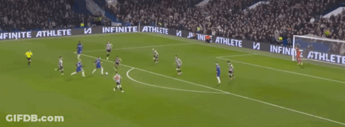 A Blurry Picture Of A Soccer Game With Players On The Field And A Crowd Watching GIF