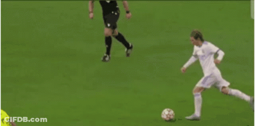 A Blurry Picture Of A Soccer Player Kicking A Soccer Ball GIF