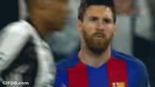 A Blurry Picture Of A Soccer Player Wearing A Blue And Red Jersey GIF