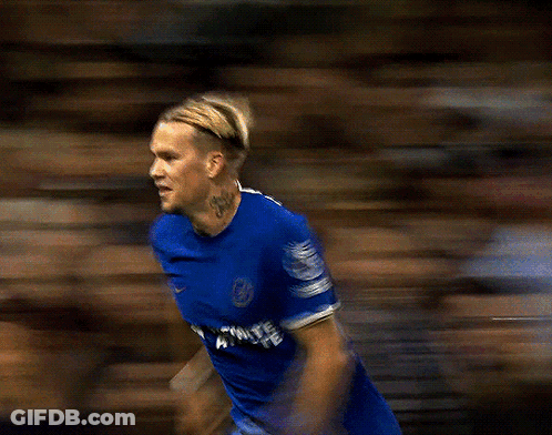 A Blurry Picture Of A Soccer Player Wearing A Blue Jersey That Says ' Premier League ' On The Sleeve GIF