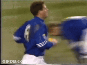 A Blurry Picture Of A Soccer Player Wearing A Blue Jersey With The Number 8 On It GIF