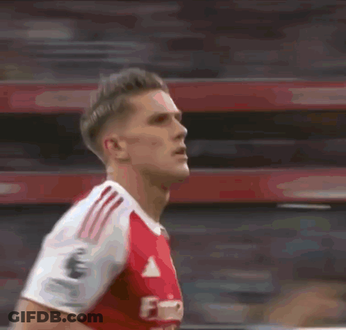 A Blurry Picture Of A Soccer Player Wearing A Red And White Adidas Jersey GIF