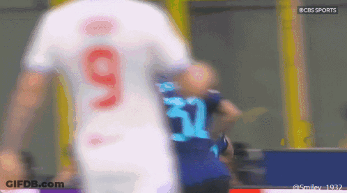 A Blurry Picture Of A Soccer Player Wearing Number 9 GIF