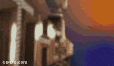 A Blurry Picture Of A Statue With A Sunset In The Background . GIF