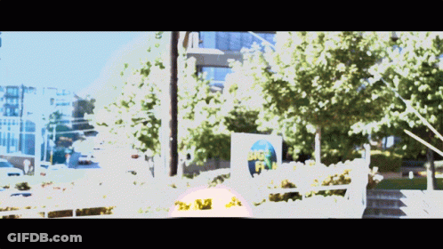 A Blurry Picture Of A Street With A Sign That Says Big Fish On It GIF