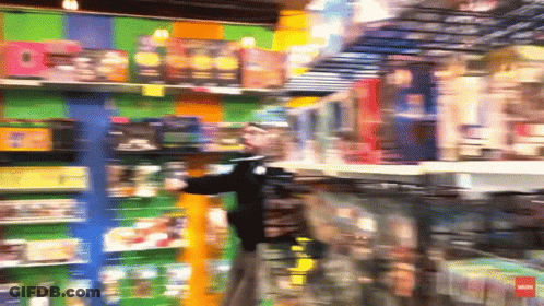 A Blurry Picture Of A Toy Store With A Red Arrow Pointing To The Left GIF